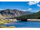 Scenic view of calm lake with bridge and mountains at 2121 Hummingbird Way # 102, Georgetown, CO 80444