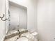 Bathroom vanity with a sink set in a granite countertop and framed by a large mirror at 4742 Quandary Peak St, Brighton, CO 80601