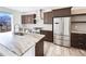 Beautiful kitchen featuring stainless steel appliances, an island, and dark wood cabinetry at 4742 Quandary Peak St, Brighton, CO 80601