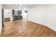 Open-concept kitchen and living area featuring gray cabinets, wood countertops, and laminate floors at 4742 Quandary Peak St, Brighton, CO 80601