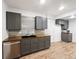 Kitchen featuring gray cabinets, stainless steel dishwasher, wood counters, and laminate floors at 4742 Quandary Peak St, Brighton, CO 80601