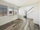 Bright living room showcasing luxury vinyl plank flooring and an open staircase at 4742 Quandary Peak St, Brighton, CO 80601