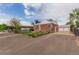 Charming brick home with a well-maintained lawn, long driveway, and detached garage at 8110 Ivy St, Commerce City, CO 80022