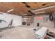 Spacious garage with concrete floors, exposed ceiling, overhead lighting, and ample storage options at 8110 Ivy St, Commerce City, CO 80022