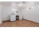 Functional laundry room with wood-look floors, washer and dryer hookups, and natural light from a window at 8110 Ivy St, Commerce City, CO 80022