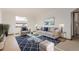 Bright living room with an area rug, painting, and neutral colored furniture at 8110 Ivy St, Commerce City, CO 80022