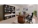 Home office featuring a large bookshelf, a wooden desk, and a comfortable office chair at 8110 Ivy St, Commerce City, CO 80022