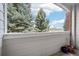 Private balcony offering views of lush greenery and blue skies, perfect for relaxing outdoors at 10259 W 55Th Dr # 103, Arvada, CO 80002