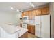 The kitchen showcases wooden cabinetry, modern appliances, and a functional breakfast bar at 10259 W 55Th Dr # 103, Arvada, CO 80002