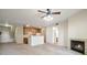 Open-concept living area with fireplace, kitchen, and bright, neutral décor at 10259 W 55Th Dr # 103, Arvada, CO 80002