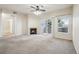 Cozy living room with a fireplace, ceiling fan, and sliding glass doors leading to a private patio at 10259 W 55Th Dr # 103, Arvada, CO 80002