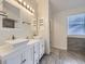 Bathroom features a double sink vanity, framed mirrors, and updated fixtures at 6447 St Vrain Ranch Blvd, Longmont, CO 80504