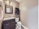 Powder bathroom features a single sink vanity with a framed mirror and a toilet with a shelf at 6447 St Vrain Ranch Blvd, Longmont, CO 80504