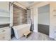 Bathroom featuring a modern tub, tiled walls, and hardwood floors at 6447 St Vrain Ranch Blvd, Longmont, CO 80504