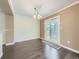 Dining room featuring hardwood floors, neutral walls, and a sliding glass door to the yard at 6447 St Vrain Ranch Blvd, Longmont, CO 80504
