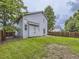 Back exterior of the home, showcasing the fenced yard and grassy lawn at 6447 St Vrain Ranch Blvd, Longmont, CO 80504