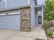 Close-up of home's entryway, highlighting brick accents and a well-manicured walkway at 6447 St Vrain Ranch Blvd, Longmont, CO 80504