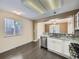 Eat-in kitchen with stainless steel appliances, granite countertops and view into the dining area at 6447 St Vrain Ranch Blvd, Longmont, CO 80504
