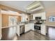 Bright kitchen features stainless steel appliances, granite countertops, and open layout to the dining area at 6447 St Vrain Ranch Blvd, Longmont, CO 80504