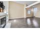 Bright living room featuring a modern fireplace, neutral walls, and hardwood floors at 6447 St Vrain Ranch Blvd, Longmont, CO 80504