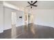 Primary bedroom features hardwood floors, a ceiling fan, and an en suite bathroom and walk in closet at 6447 St Vrain Ranch Blvd, Longmont, CO 80504