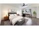 Bedroom with a king bed, nightstands, a desk, and large windows with curtains at 6447 St Vrain Ranch Blvd, Longmont, CO 80504