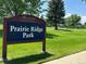 Prairie Ridge Park sign surrounded by green grass and beautiful trees at 6447 St Vrain Ranch Blvd, Longmont, CO 80504