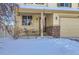 Covered front porch with seating for two and an American flag at 5834 Twilight Ave, Firestone, CO 80504