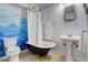 Bathroom with clawfoot tub, mountain mural and modern vanity at 6997 S Columbine Rd, Evergreen, CO 80439