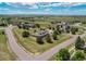 Wide aerial view featuring a home with a large lot and mature trees offering beautiful views and curb appeal at 895 Antelope W Dr, Bennett, CO 80102