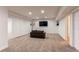 Finished basement with plush carpet and a wall-mounted television at 895 Antelope W Dr, Bennett, CO 80102