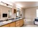 Bright bathroom with dual sinks, neutral color palette and a relaxing soaking tub at 895 Antelope W Dr, Bennett, CO 80102