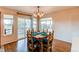 Bright dining room with rustic table, chandelier, and sliding doors to the outside at 895 Antelope W Dr, Bennett, CO 80102