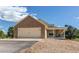 Charming home with a brick and siding facade, featuring an attached two-car garage and cozy front porch at 895 Antelope W Dr, Bennett, CO 80102