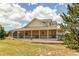 Inviting home exterior featuring a large covered porch, perfect for relaxing and enjoying the outdoor scenery at 895 Antelope W Dr, Bennett, CO 80102