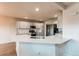 Modern kitchen featuring white cabinets, quartz countertops, and stainless steel appliances at 895 Antelope W Dr, Bennett, CO 80102