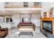 Comfortable living room features a cozy fireplace and an open view of the kitchen and staircase at 895 Antelope W Dr, Bennett, CO 80102