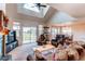 Bright living room with a vaulted ceiling, fireplace, and large windows with backyard view at 895 Antelope W Dr, Bennett, CO 80102