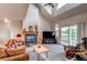 Inviting living room features a fireplace, vaulted ceilings, and large windows for ample natural light at 895 Antelope W Dr, Bennett, CO 80102