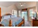 Comfortable bedroom with vaulted ceilings, ceiling fan, and a sliding glass door to the outside at 895 Antelope W Dr, Bennett, CO 80102