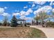 Community park featuring a playground, picnic shelter, mature trees, and walking path at 895 Antelope W Dr, Bennett, CO 80102