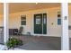 Welcoming front porch with comfortable seating, a decorative plant, and a charming, secure entryway at 895 Antelope W Dr, Bennett, CO 80102