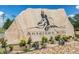 Entrance sign for Antelope Hills Golf Community featuring landscaping and stone monument at 895 Antelope W Dr, Bennett, CO 80102