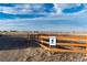 Community trail with a wooden fence and trailhead sign, indicating walking access at 895 Antelope W Dr, Bennett, CO 80102