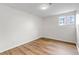 Empty bedroom features wood floors, neutral walls, and a window at 3613 S Sheridan Blvd # 7, Denver, CO 80235