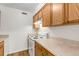 Well-lit kitchen offering wood cabinets, a white range, and neutral countertops at 3613 S Sheridan Blvd # 7, Denver, CO 80235
