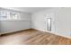 The spacious living room has wood floors, neutral walls, and a front entrance at 3613 S Sheridan Blvd # 7, Denver, CO 80235