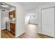An open floor plan showcases the kitchen with white appliances and wood floors throughout at 3613 S Sheridan Blvd # 7, Denver, CO 80235