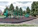 A community playground has green slides, climbing equipment, and a soft surface at 3613 S Sheridan Blvd # 7, Denver, CO 80235