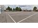 Exterior view of the community tennis courts and playground with mature trees at 3613 S Sheridan Blvd # 7, Denver, CO 80235